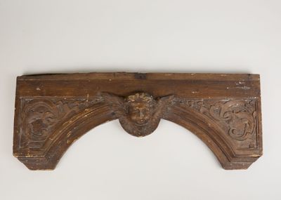 an antique carved wood shelf with a lion head on it