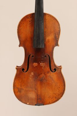 an old violin with a bow hanging from it ' s back