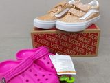 a pair of pink shoes and a pink shoe on a box