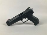 a black gun on a white surface with a white background