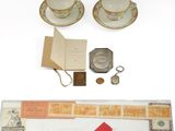 two cups and saucers and a book on the table