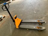 a fork lifter sitting on the ground in a garage