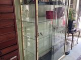 a glass display case in the corner of a room