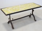 an image of a table with a yellow tile top and iron legs