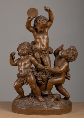 bronze statue of a group of children playing with a ball