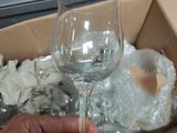 a person holding a wine glass in a box