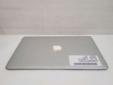 an apple macbook air laptop computer sitting on top of a white table