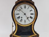 a black and gold clock with roman numerals on it