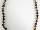 a necklace made of tiger ' s eye beads with a gold clasp