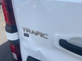 the rear end of a white van with the word traffic written on it