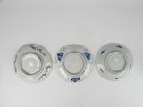 three blue and white plates sitting next to each other on a white surface