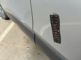 a sticker on the side of a car with a ruler attached to it