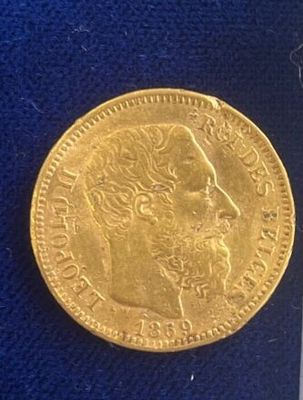 a close up of a gold coin on a blue cloth