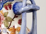 a blue and white vase with a flower design on it