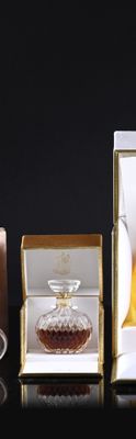 three different types of perfumes in a box on a table