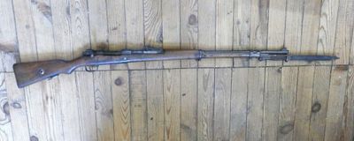 a rifle mounted on the wall of a wooden room
