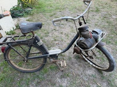 a old bike that is sitting in the grass