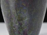a close up of a vase on a table
