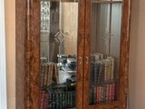 a large wooden cabinet with many books on top of it