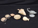 several pieces of pottery sitting on top of a black surface