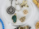 a lot of jewelry sitting on a white surface