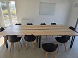 a long table with chairs around it in the middle of a room