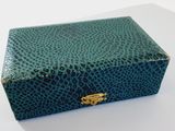 an image of a green box with a gold clasp on it