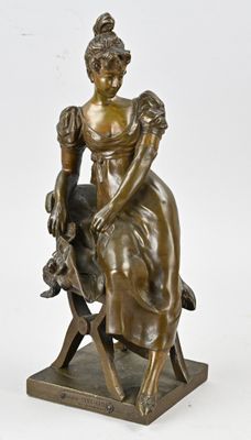 an antique bronze statue of a woman sitting on a chair