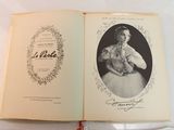 an old book with a picture of a woman in a dress
