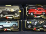 three toy cars are sitting in a box on a black surface