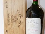 a bottle of wine sitting next to a wooden box