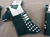 two pairs of green socks with white polka dots on them