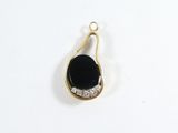a close up of a black and white pendant on a white surface