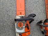 two chains attached to a chainsaw on the ground