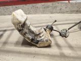a broken shoe sitting on the ground next to a pair of shoes