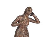 bronze statue of a woman talking on a cell phone