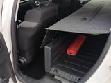 a white van with luggage in the back of it