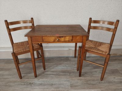 a small table and two chairs in a room