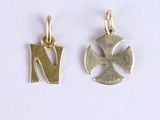 two gold charms with the letter n and a cross on them