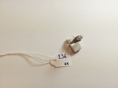 a tag that says 25 cents on it next to an earphone