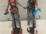 two dolls that are standing next to each other
