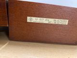 a wooden box with a label on it sitting on the floor