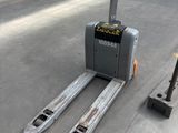 a forklift that is sitting on the ground next to a pole
