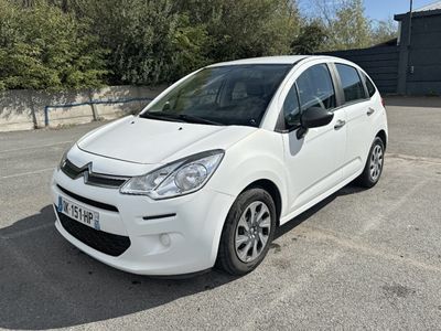 a picture of a small white car parked in a parking lot