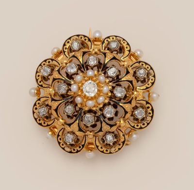 a close up of a gold and diamond broochle