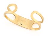 a close up of a gold cuff with two open circles