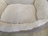 a dog that is laying in a dog bed on the floor
