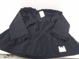 a black dress with a white tag on it