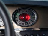 a close up of a car dashboard with a red light