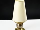 a lamp that is sitting on a table with a black background